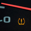 What causes the service tire monitor system to come on?