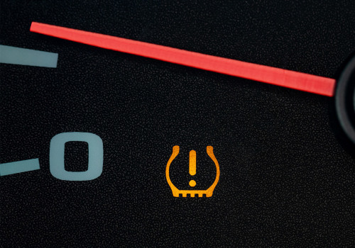 What causes the service tire monitor system to come on?